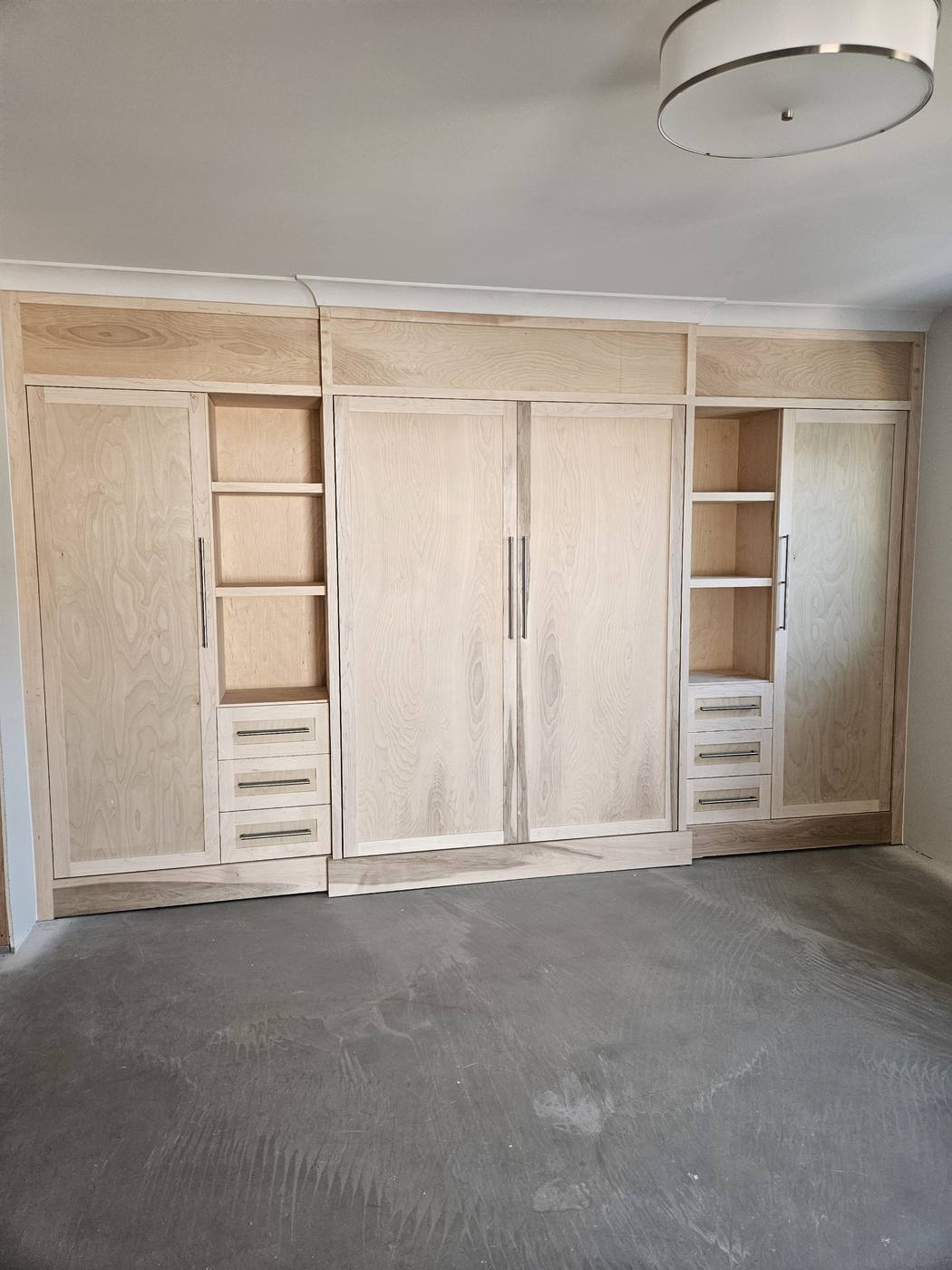 Custom murphy bed built with surrounding cabinetry