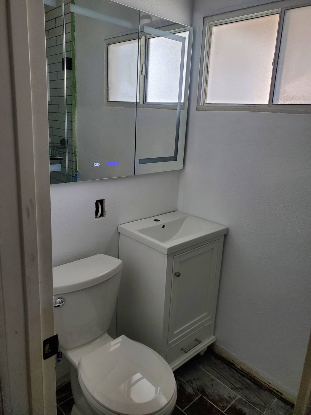 Small bathroom refreshed with new fixtures and finishes