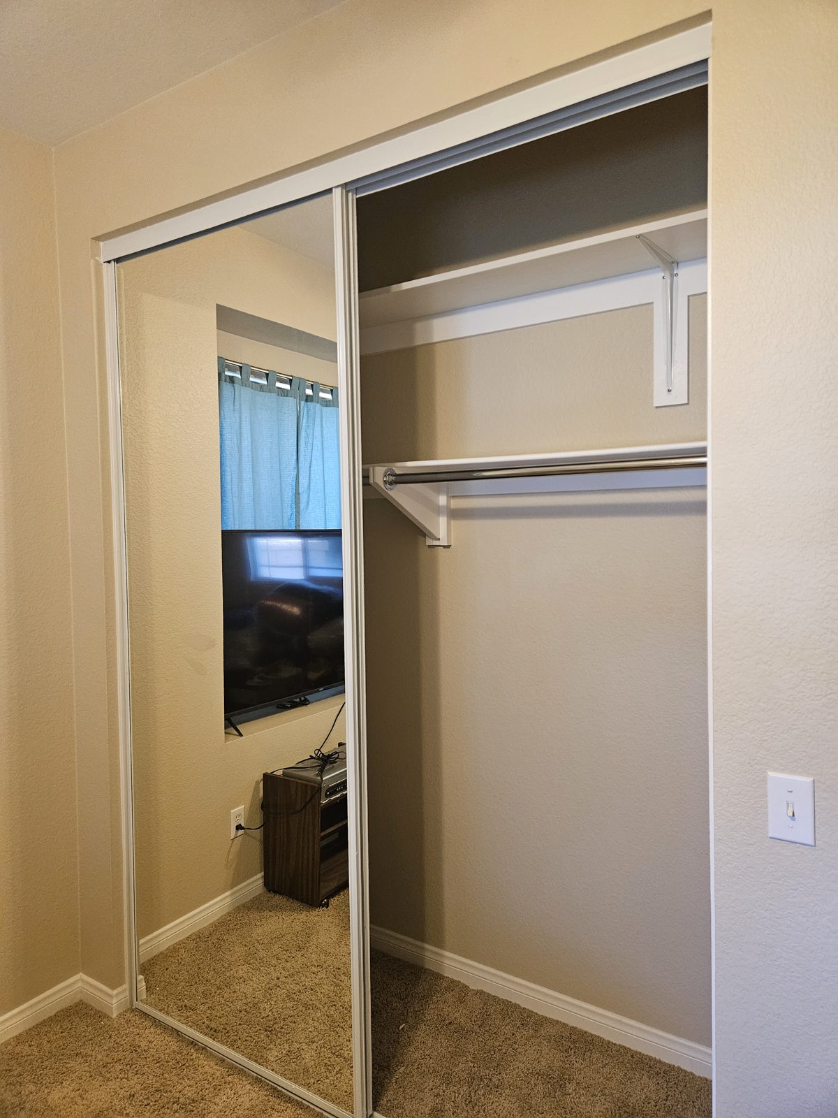 Mirrored closet doors with new shelving installed