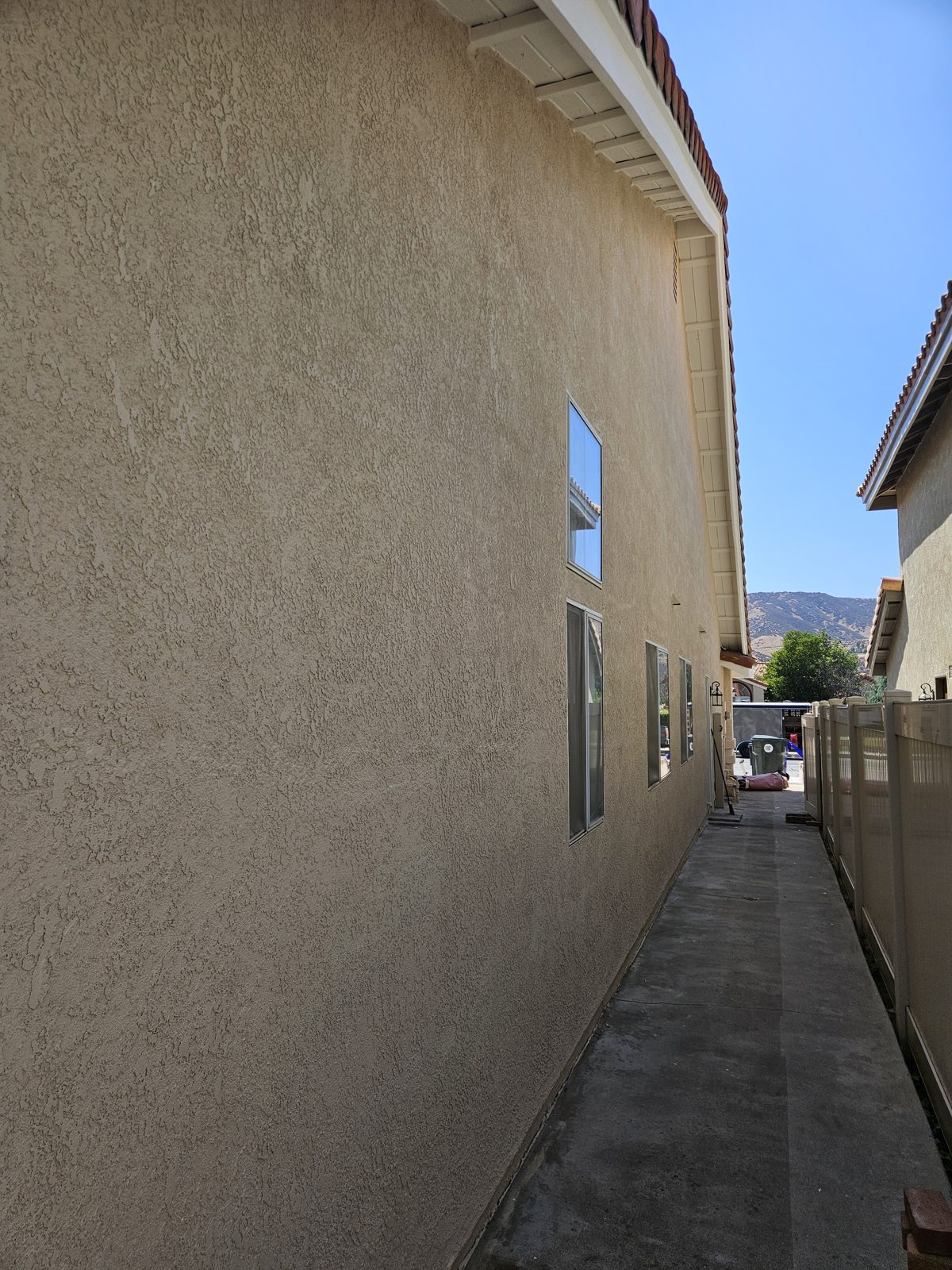 Stucco and eaves repaired and repainted