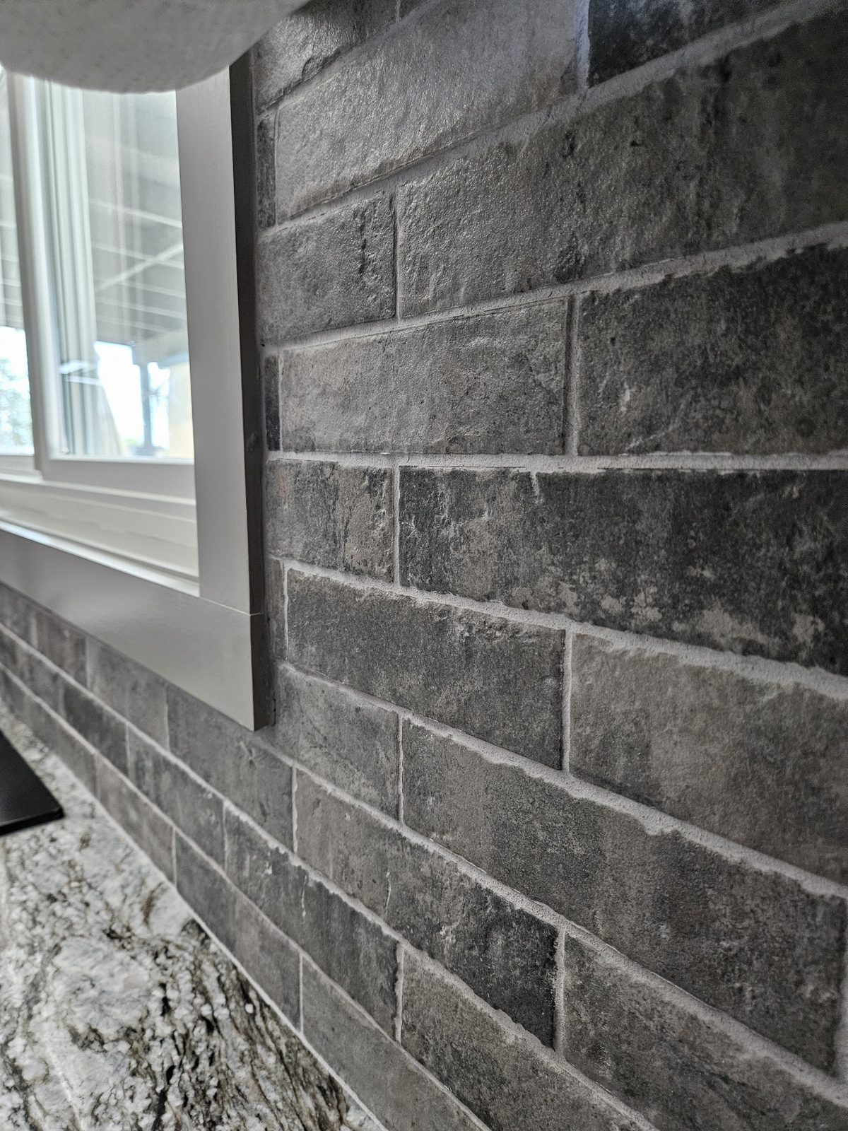 New tile backsplash installed behind a kitchen range