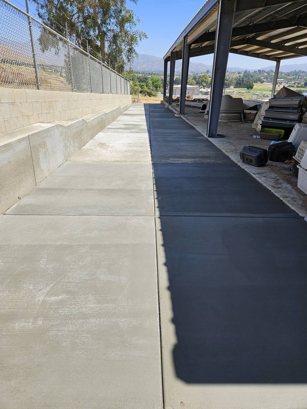 Concrete walkway poured next to a new retaining wall