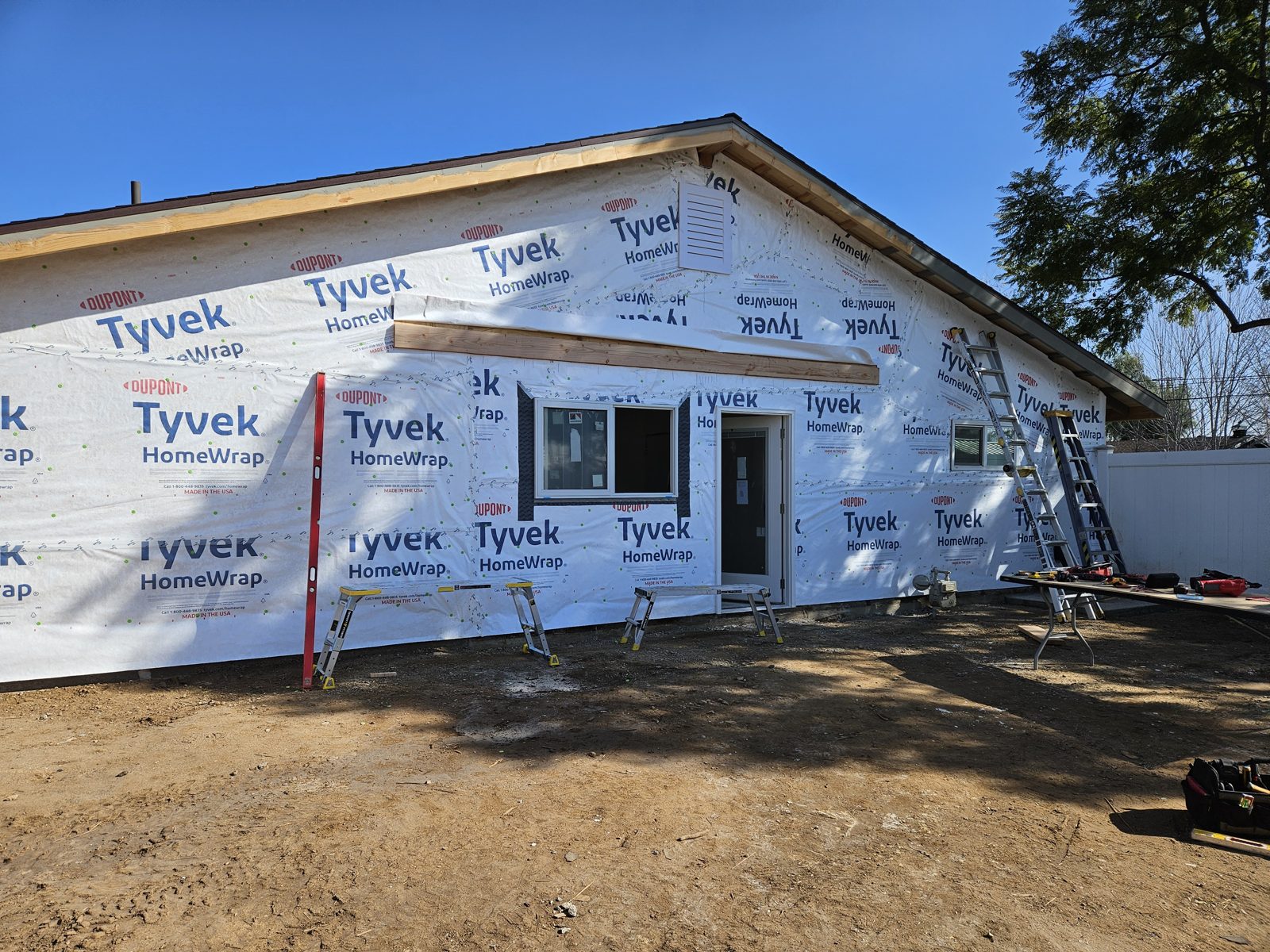 Home addition framed and wrapped in housewrap
