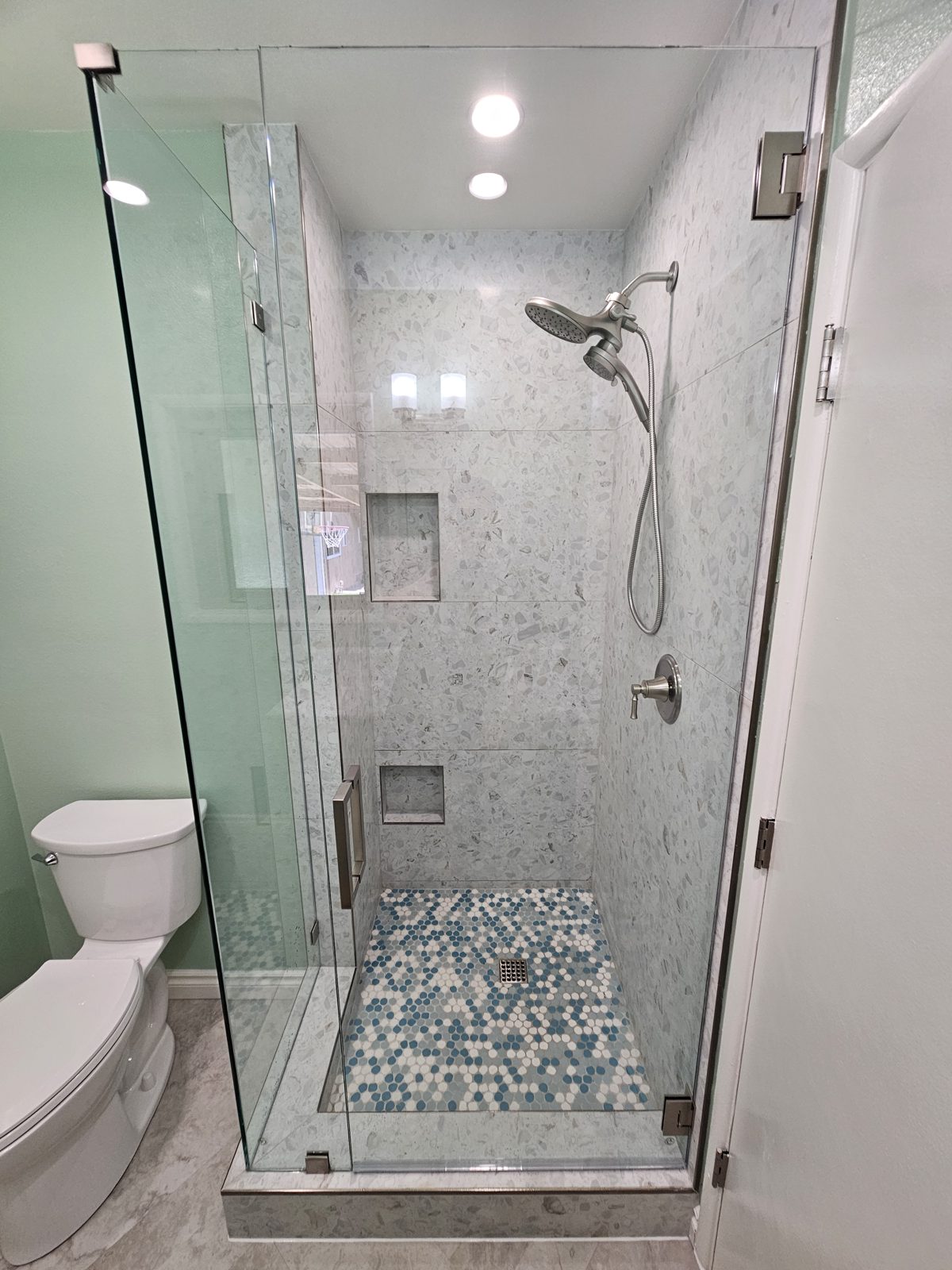 Custom tiled walk-in shower with glass enclosure built in a Yucaipa, CA bathroom remodel