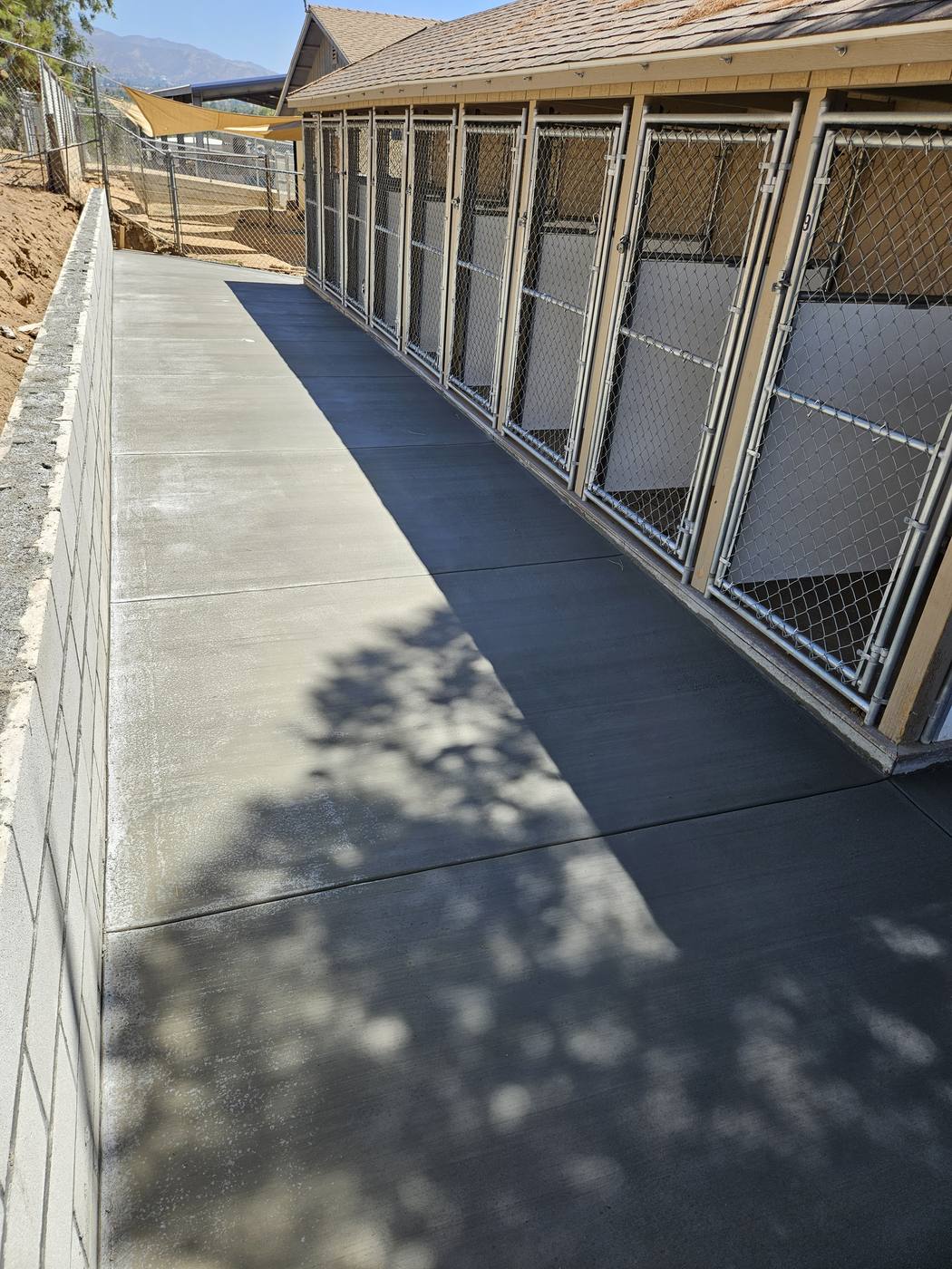 Block retaining wall built alongside a dog kennel