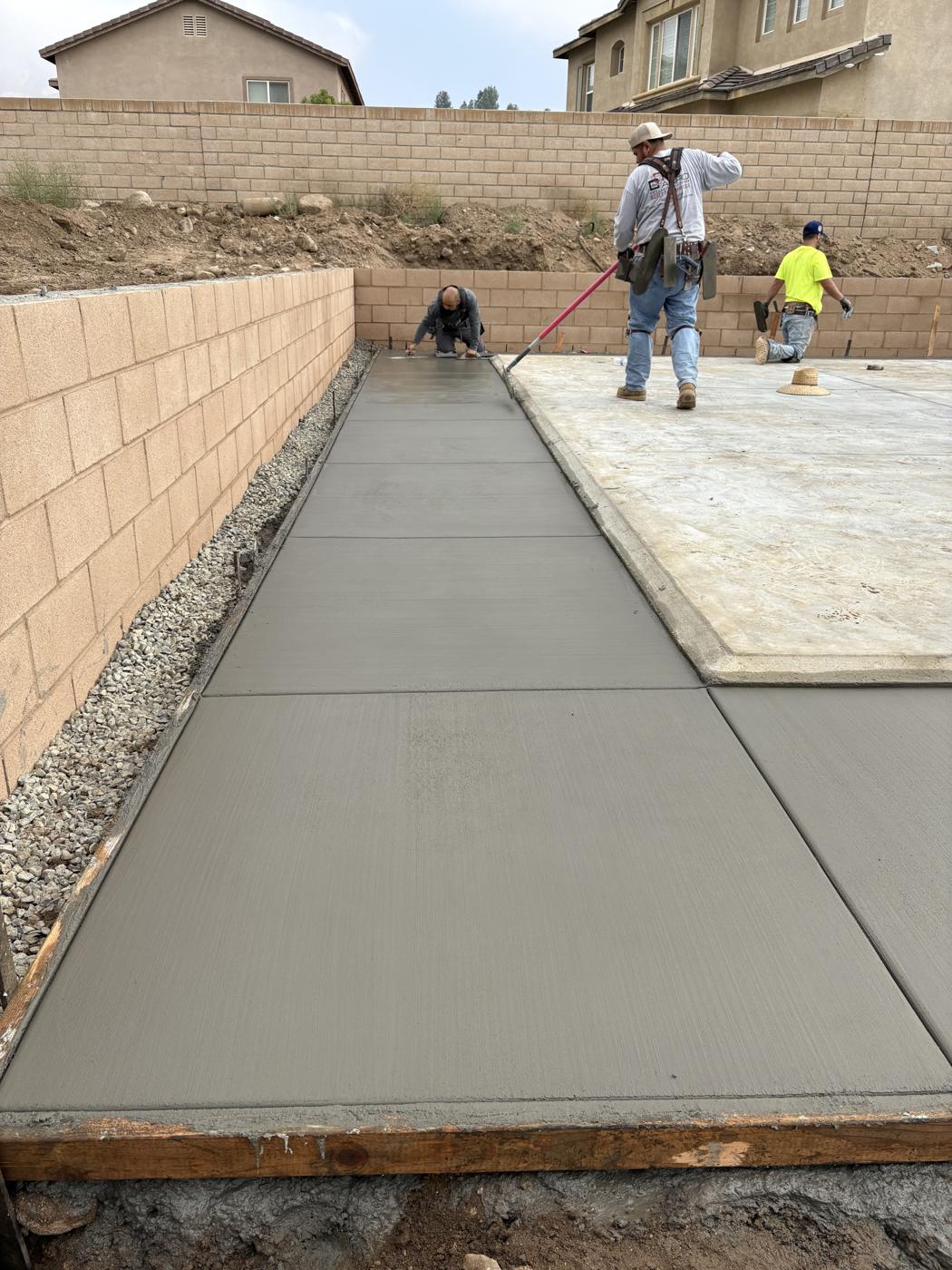 New concrete slab with a block retaining wall