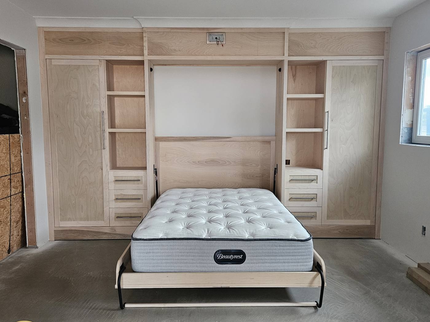 Murphy bed installed with built-in cabinets