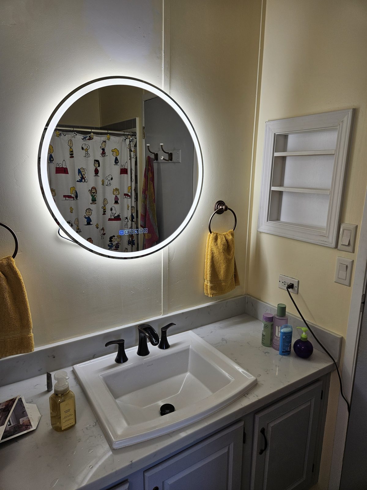 Backlit LED mirror installed above a bathroom vanity