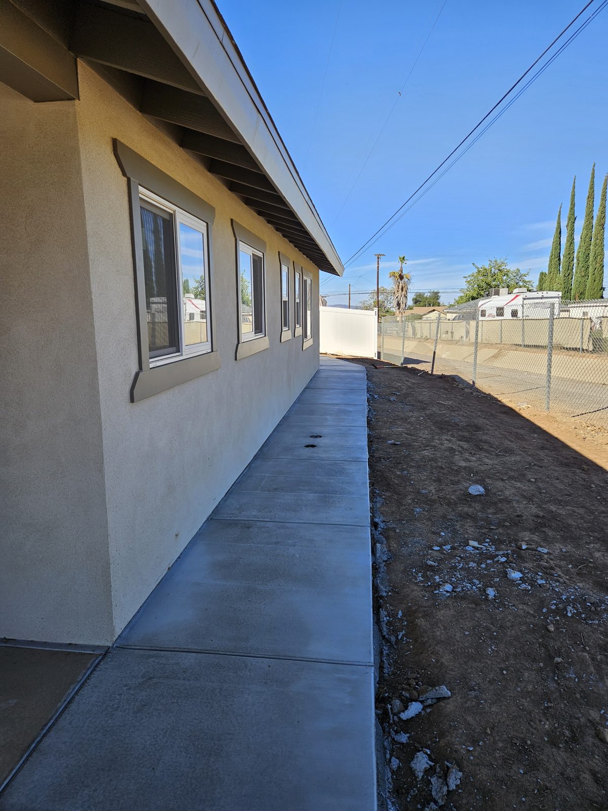 Finished concrete walkway alongside a home