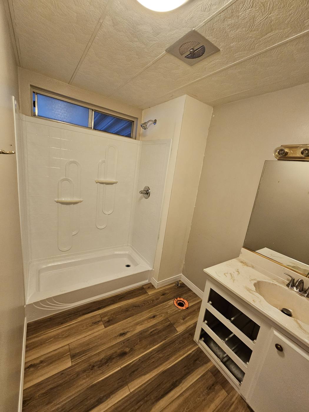 New shower insert installed in a bathroom