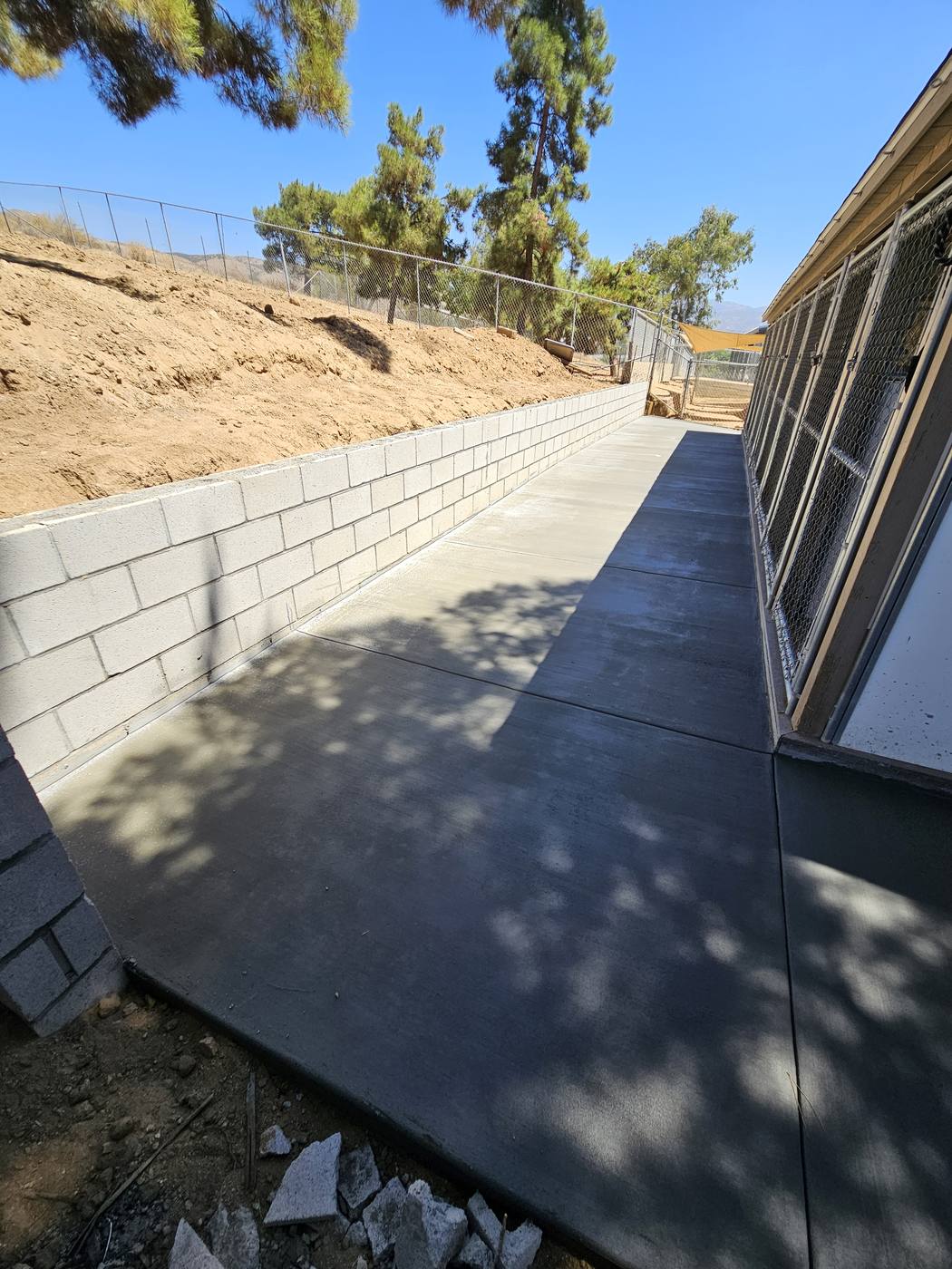 Retaining wall built with a new concrete walkway