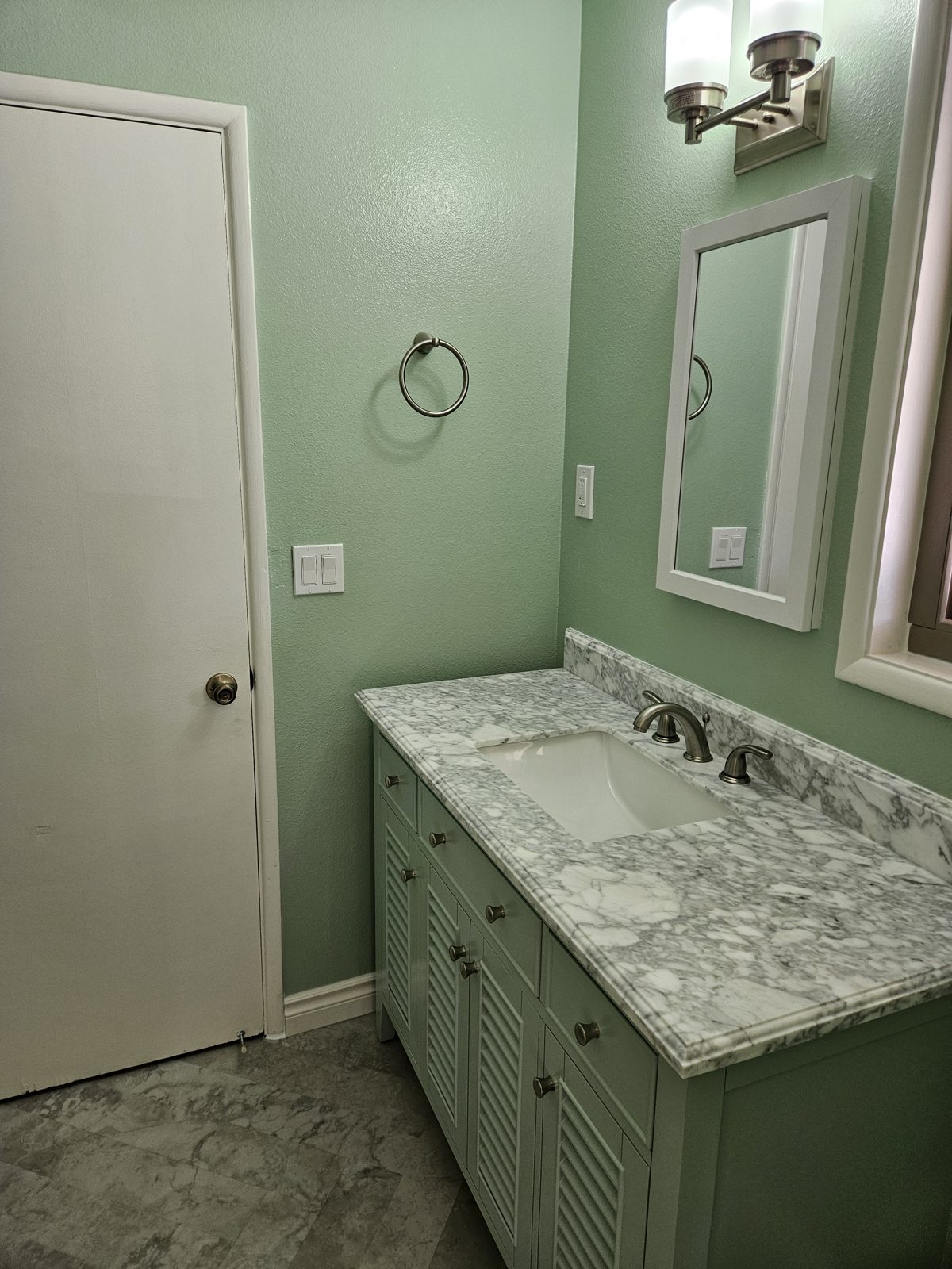 Bathroom refresh with updated vanity, mirror and lighting