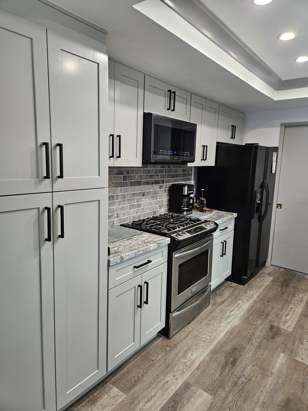 Remodeled kitchen with custom cabinetry and tile backsplash