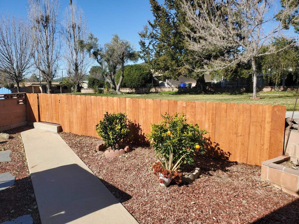 New wood fence built around a backyard