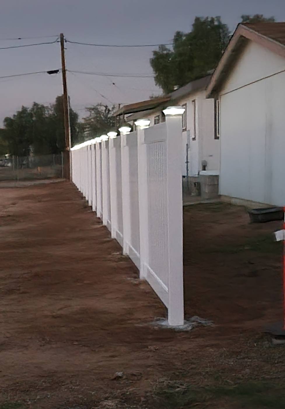 White vinyl fence installed along a yard
