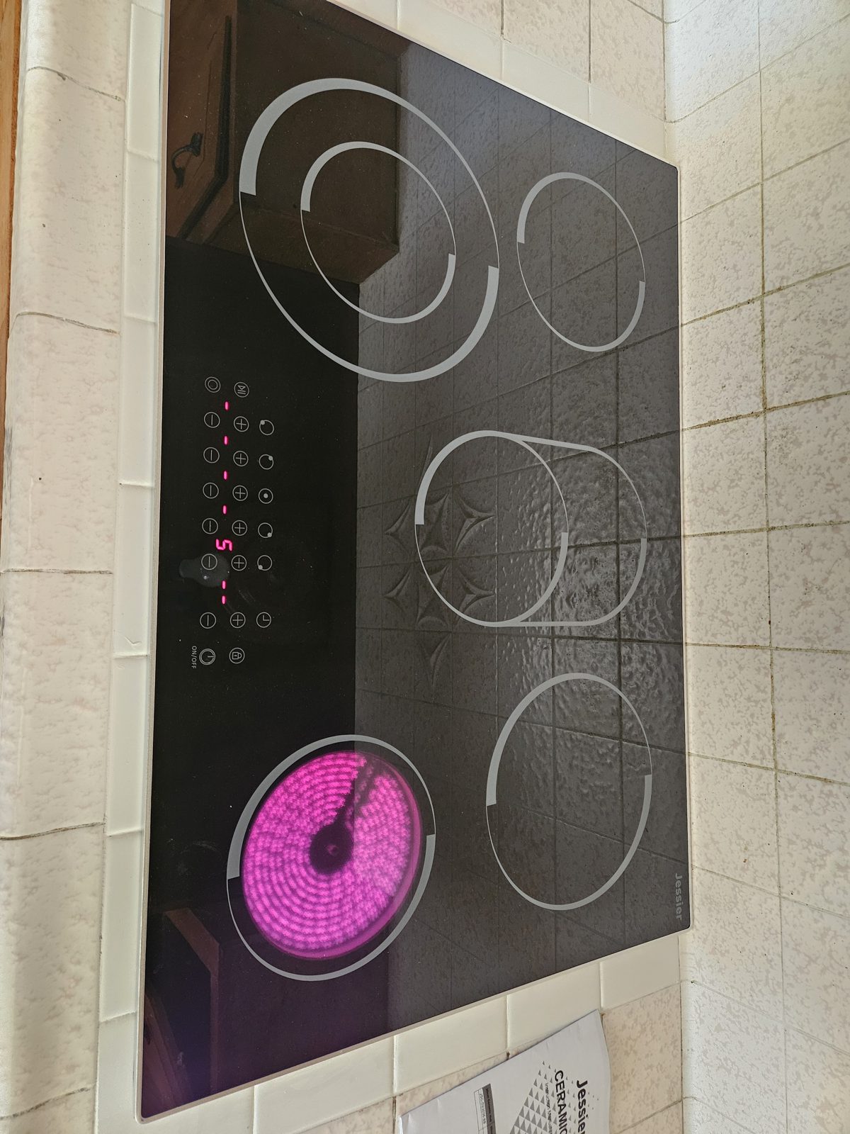 New electric cooktop installed in a quartz countertop