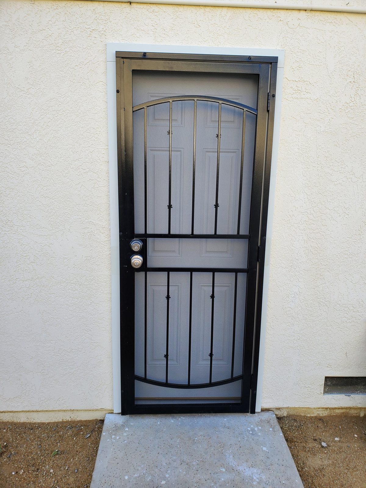 Security screen door installed on a home